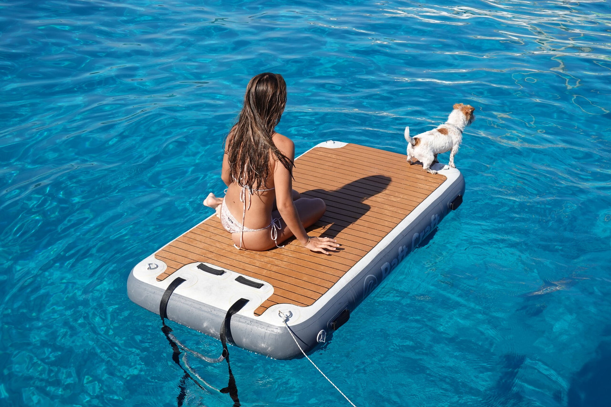 RC101 floating dock with a dog standing on the teak-effect deck